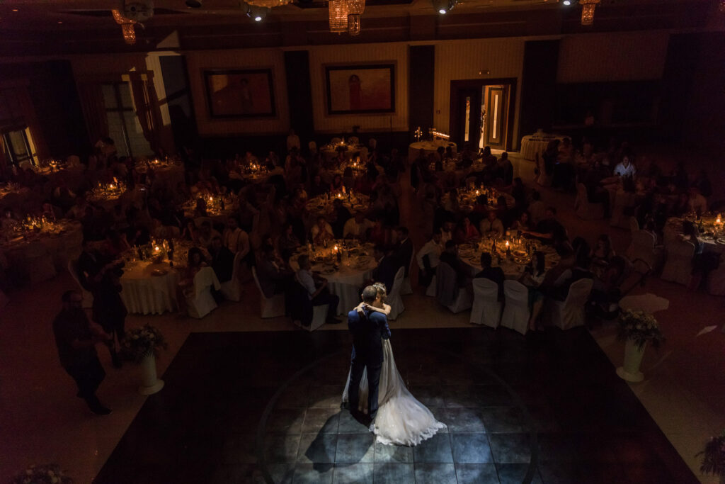 Bride and groom first dance elegant ballroom crystal chandeliers Greece wedding reception destination wedding photography