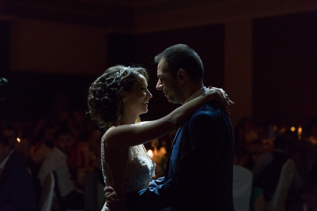 Bride and groom first dance elegant ballroom crystal chandeliers Greece wedding reception destination wedding photography