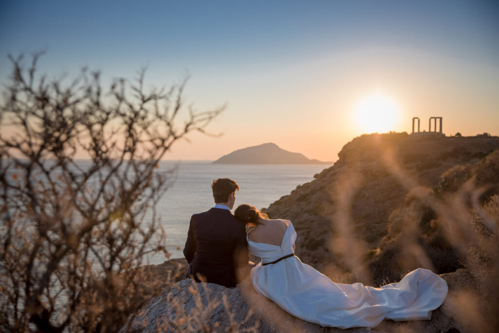 Bride and groom dancing sunset Temple of Poseidon Cape Sounion Greece ancient columns coastal landscape destination wedding photography