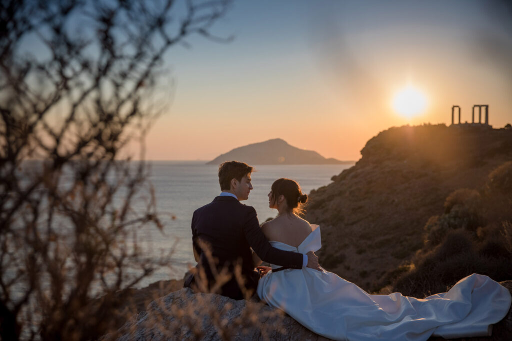 Bride and groom dancing sunset Temple of Poseidon Cape Sounion Greece ancient columns coastal landscape destination wedding photography