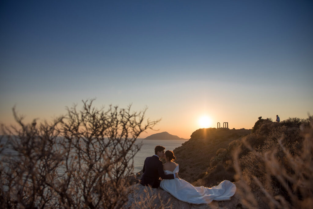 Bride and groom dancing sunset Temple of Poseidon Cape Sounion Greece ancient columns coastal landscape destination wedding photography