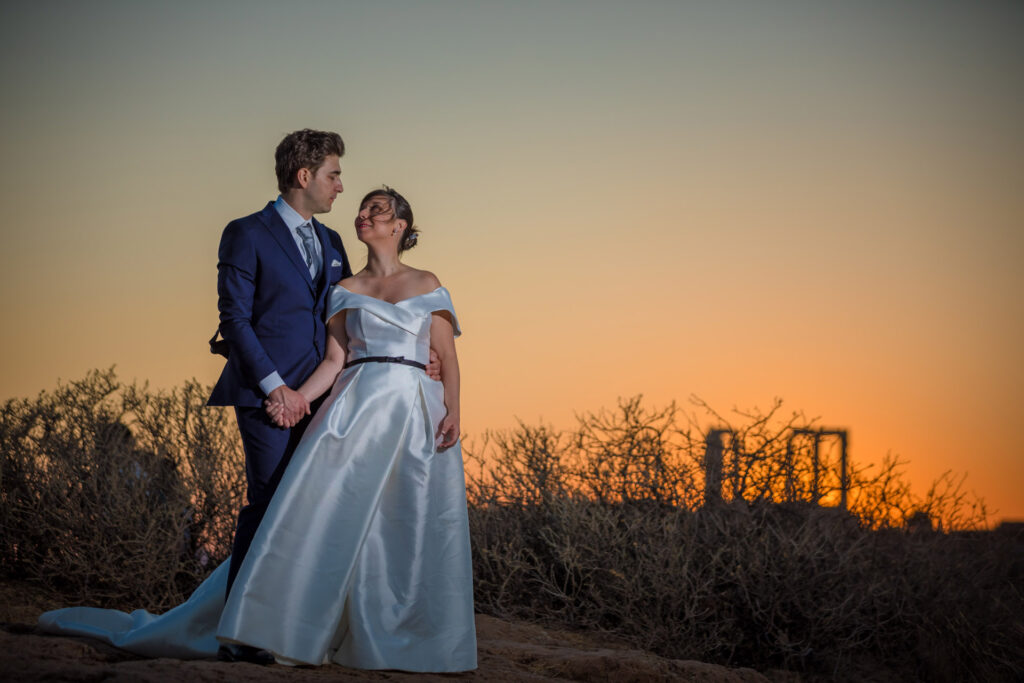 Bride and groom dancing sunset Temple of Poseidon Cape Sounion Greece ancient columns coastal landscape destination wedding photography